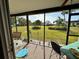 Screened patio offering neighborhood views, complete with outdoor seating and decor at 11310 Carriage Hill Dr # 4, Port Richey, FL 34668