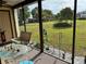 Enjoy the outdoors from this screened patio with chairs, tables and garden views at 11310 Carriage Hill Dr # 4, Port Richey, FL 34668