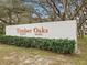 Timber Oaks community entrance sign displays neighborhood name with lush green landscaping at 11310 Carriage Hill Dr # 4, Port Richey, FL 34668