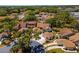 This aerial showcases the community's lovely homes, mature trees, and proximity to nearby amenities at 11735 Rolling Pine Ln, Port Richey, FL 34668