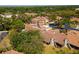 Expansive aerial view of a well-planned community surrounded by trees and lush green spaces at 11735 Rolling Pine Ln, Port Richey, FL 34668