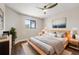 Bedroom with hardwood floors, large window, and modern decor at 11735 Rolling Pine Ln, Port Richey, FL 34668