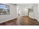This light-filled bedroom boasts hardwood floors and ample natural light from a large window at 11735 Rolling Pine Ln, Port Richey, FL 34668