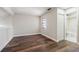 Bedroom with wood floors and entry to attached bathroom at 11735 Rolling Pine Ln, Port Richey, FL 34668