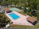 Inviting community pool area with ample seating and well-maintained landscaping for residents' enjoyment at 11735 Rolling Pine Ln, Port Richey, FL 34668