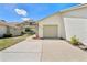 Exterior of home showing attached garage and neutral color scheme at 11735 Rolling Pine Ln, Port Richey, FL 34668