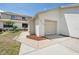 Home exterior showing attached garage and walkway at 11735 Rolling Pine Ln, Port Richey, FL 34668