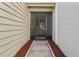 Screened front porch with concrete walk and mulched beds at 11735 Rolling Pine Ln, Port Richey, FL 34668