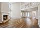Spacious living room with wood floors, fireplace, and a staircase to the second floor at 11735 Rolling Pine Ln, Port Richey, FL 34668