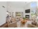 Bright living room features a fireplace, wood floors, and sliding glass doors to the lanai at 11735 Rolling Pine Ln, Port Richey, FL 34668