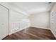 Bright loft area with hardwood floors and a white railing overlooking the lower level at 11735 Rolling Pine Ln, Port Richey, FL 34668