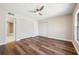 Bright main bedroom featuring wood floors, neutral paint and a ceiling fan at 11735 Rolling Pine Ln, Port Richey, FL 34668