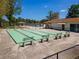 Shuffleboard courts and a nearby pool for recreation in this community at 11735 Rolling Pine Ln, Port Richey, FL 34668
