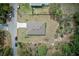 Overhead shot of the home, situated on a spacious lot with mature landscaping and proximity to a neighboring pool at 12201 Labrador Duck Labrador Duck Rd, Weeki Wachee, FL 34614