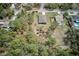 Expansive aerial view showcasing a charming single-Gathering home with a well-maintained lawn and tree-lined property at 12201 Labrador Duck Labrador Duck Rd, Weeki Wachee, FL 34614
