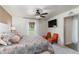 Comfortable bedroom boasts a ceiling fan, large bed, TV, and seating area with bright armchairs at 12201 Labrador Duck Labrador Duck Rd, Weeki Wachee, FL 34614