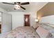 Bedroom features stylish ceiling fan, large bed with colorful linens, and access to ensuite bathroom at 12201 Labrador Duck Labrador Duck Rd, Weeki Wachee, FL 34614