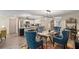 Modern dining area with stylish chairs, a glass-top table, and an adjacent kitchen at 12201 Labrador Duck Labrador Duck Rd, Weeki Wachee, FL 34614
