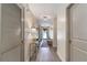 Bright hallway with decor, wood floors, and natural light shining through front door at 12201 Labrador Duck Labrador Duck Rd, Weeki Wachee, FL 34614