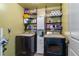 Well-organized laundry room with washer, dryer, and shelving for storage at 12201 Labrador Duck Labrador Duck Rd, Weeki Wachee, FL 34614