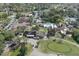 Community featuring a pool, tennis courts, and lush greenery from an aerial perspective at 12505 Dearborn Dr # C, Hudson, FL 34667