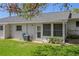 Exterior back view of house with well-maintained lawn and an air conditioning unit at 12505 Dearborn Dr # C, Hudson, FL 34667