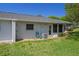 Back exterior of home featuring a well maintained lawn, and an A/C unit at 12505 Dearborn Dr # C, Hudson, FL 34667