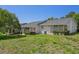 Back exterior view featuring a well maintained lawn, and a screened in porch at 12505 Dearborn Dr # C, Hudson, FL 34667
