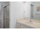 Clean bathroom featuring a vanity with sink, a large mirror, and a glass-enclosed shower at 12505 Dearborn Dr # C, Hudson, FL 34667