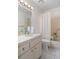 Bright bathroom features a vanity, toilet, and a bathtub with shower and accessibility bars at 12505 Dearborn Dr # C, Hudson, FL 34667