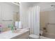 Neutral bathroom featuring an extended marble vanity, shower, and toilet at 12505 Dearborn Dr # C, Hudson, FL 34667