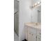 Bathroom with large mirror, a vanity with sink, storage drawers and glass-enclosed shower at 12505 Dearborn Dr # C, Hudson, FL 34667