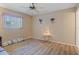 Bright bedroom with modern floors, a ceiling fan, and natural light from the window at 12505 Dearborn Dr # C, Hudson, FL 34667