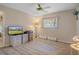 Bedroom featuring modern floors, ceiling fan, window, and ample space for furniture at 12505 Dearborn Dr # C, Hudson, FL 34667