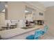 Bright kitchen with breakfast bar, white cabinets, and stainless steel appliances at 12505 Dearborn Dr # C, Hudson, FL 34667