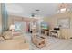 Bright living room featuring tile flooring, neutral decor, and ample space at 12505 Dearborn Dr # C, Hudson, FL 34667