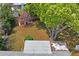 Aerial view of backyard featuring large trees, shed and surrounding greenery at 12613 Social Dr, Hudson, FL 34667