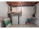 Unfinished basement laundry area with a utility sink, water heater and modern washer and dryer units at 12613 Social Dr, Hudson, FL 34667