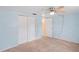 Bright bedroom featuring a ceiling fan, closet, and neutral carpet at 12613 Social Dr, Hudson, FL 34667