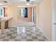 Open-concept dining area with a checkered floor, connecting the kitchen and living spaces at 12613 Social Dr, Hudson, FL 34667
