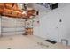 A view of the garage interior showing exposed rafters, storage and the interior garage door at 12613 Social Dr, Hudson, FL 34667
