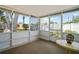 Screened porch featuring a decorative table with backyard views at 12613 Social Dr, Hudson, FL 34667