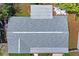 Aerial view of a well maintained roof with a light gray color and with a mix of greenery around the house at 12613 Social Dr, Hudson, FL 34667