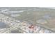 Scenic aerial view of a waterfront residential area featuring canals, boat docks, and lush greenery at 12801 5Th Isle, Hudson, FL 34667