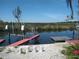 Backyard view of canal featuring a boat dock and lift on the water at 12801 5Th Isle, Hudson, FL 34667