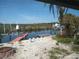 View of canal and boat dock area from backyard, featuring a dock and distant landscape at 12801 5Th Isle, Hudson, FL 34667