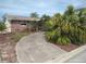 Attractive brick home with lush landscaping, a curved driveway, and a classic design at 12801 5Th Isle, Hudson, FL 34667