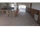 Spacious kitchen area in progress, featuring tile flooring and access to an outdoor patio at 12801 5Th Isle, Hudson, FL 34667