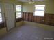 Sunroom with a door and two windows, ready for renovation at 12801 5Th Isle, Hudson, FL 34667