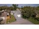 Aerial view of the home, showcasing its landscaped front yard and driveway at 152 Chelsea Ct, Dunedin, FL 34698